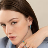 Back to Origin earrings with light blue topaz