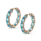 Back to Origin earrings with light blue topaz
